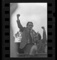 Chicago Seven attorney William M. Kunstler at microphone with arm raised during Los Angeles protest rally, 1970