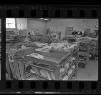 Superintendent of mail surrounded by stacks of mail during postal strike in Northridge, Calif., 1970