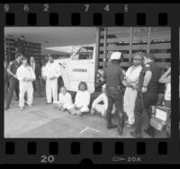 Police detaining Greenpeace members at Occidental Petroleum meeting in Los Angeles, Calif., 1986
