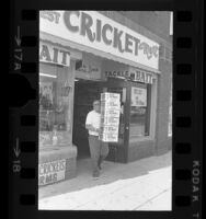 Ken Jenkins carrying boxes of crickets from his Cricket Mart store in Venice, Calif., 1970