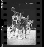 Chicago Bulls player Matt Guokas trying to steal ball from Los Angeles Laker, Wilt Chamberlain, 1971