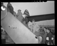 Director John Ford and actor Ward Bond boarding plane at LAX, 1950