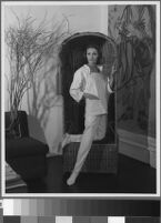 Black and white photographs of Cashin's ready-to-wear designs for Sills and Co., modeled in residential interiors including Cashin's New York apartment.