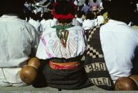 Guelaguetza[?], performers sitting with spectators [view from behind], 1982 or 1985
