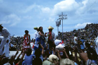 Chines de Oaxaca, performers throwing gifts to spectators, 1982