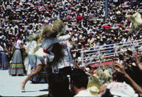 Tlaxiaco, performers throwing straw hats to spectators, 1982 or 1985