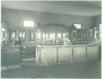 Bar and cigar counter with three people at Universal City, Calif., circa 1915