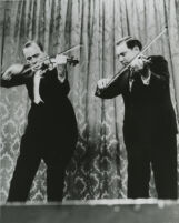 Jack Benny and Isaac Stern playing violins, 1955