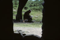 Oaxaca, old man reading a book outside, 1982 or 1985