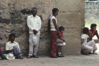 Oaxaca, people waiting by building, 1982 or 1985
