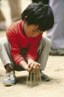Oaxaca, boy playing in sand, 1982 or 1985