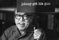 Dalton Trumbo, portrait holding sign reading "johnny got his gun"