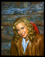 Jo Ann Smith in leather fringed coat and red hat, circa 1936-1945