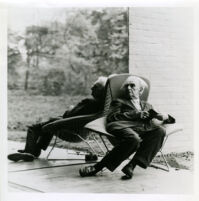 Richard J. Neutra in chair before mirror, circa 1960
