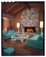 living room with fireplace and turquoise couches