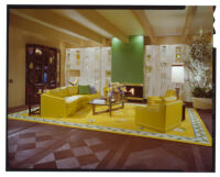 living room with yellow couches and rug