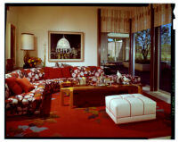 living room with red flowered sectional sofa