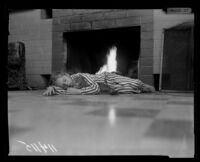 Survivor of Fountain of the World headquarters bombing Jesse Vezina sleeps with her cat in front of the fireplace, 1958.