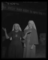 Bishop Nekona raises her palms to the sky as Sister Muriel watches in the ruins of the headquarters of Fountain of the World, 1958.