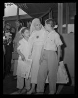 Mother Ruth, widow of Krishna Venta, reunites with two of her daughters at Los Angeles International Airport, 1958.