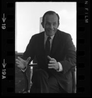 Daniel Ritchie, executive vice president-finance of MCA sits during an interview with himself and President/CEO Lew Wasserman. C. 1969.