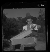 Wallace Farelly, University Elementary School student, operates flax brake, 1958.