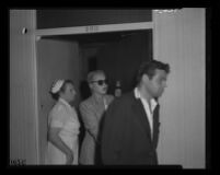 Barbara Payton leaves Franchot Tone’s hospital room, following Jerry Bialac, a mutual friend, 1951.