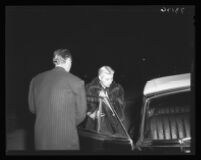 Franchot Tone holds car door for Barbara Payton at Romanoff's, a night spot, 1951.
