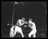 Cisco Andrade, left, punches Art Aragon, 1956.