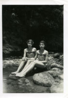 Two girls sitting on rocks