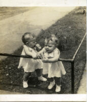 Two baby girls holding film
