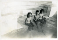 Children sitting in a pool