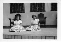Two girls sitting down