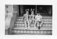 Three children sitting on steps