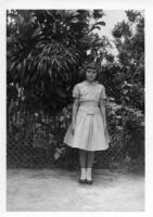 Girl posing by garden
