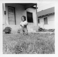 Little girl in front of house