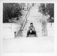 Boy sitting at bottom of stairs