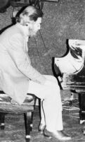 Bill Evans seated at a piano [descriptive]