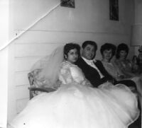 Husband and Wife sitting with bridesmaids