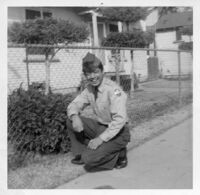 Soldier sitting in front of house