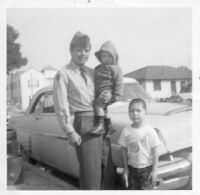 Soldier with children in front of car