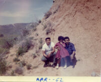 Family posing on a hill