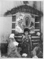 Little girl with Virgen de Guadalupe altar