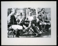 Snowy Baker, Glenn Garbutt, Hal Roach, Winslow Felix and Big Boy Williams watching a polo match, [1936].