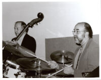 Jim Hughart playing double bass and an unidentified drummer, Los Angeles [descriptive]