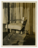 Chair against curtain backdrop, undated