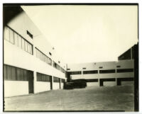 Exterior rear view of building with man and car