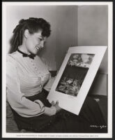 Jane Russell admiring a crew member's artwork on the set of The Paleface
