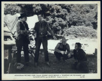 Johnny Mack Brown, John Merton and unidentified cast members in a scene from Shadows on the Range
