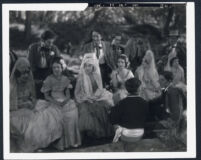 Renee Adoree with extras on the set of Tide Of Empire